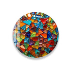 The image is a vibrant and colorful mosaic composed of numerous small, multicolored glass pieces arranged in a circular pattern.