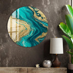 a large circular wall art piece with a swirling design of turquoise and gold colors, hanging on a dark wall. To the right of the art piece, there is a lamp and a small silver ball on a wooden shelf.