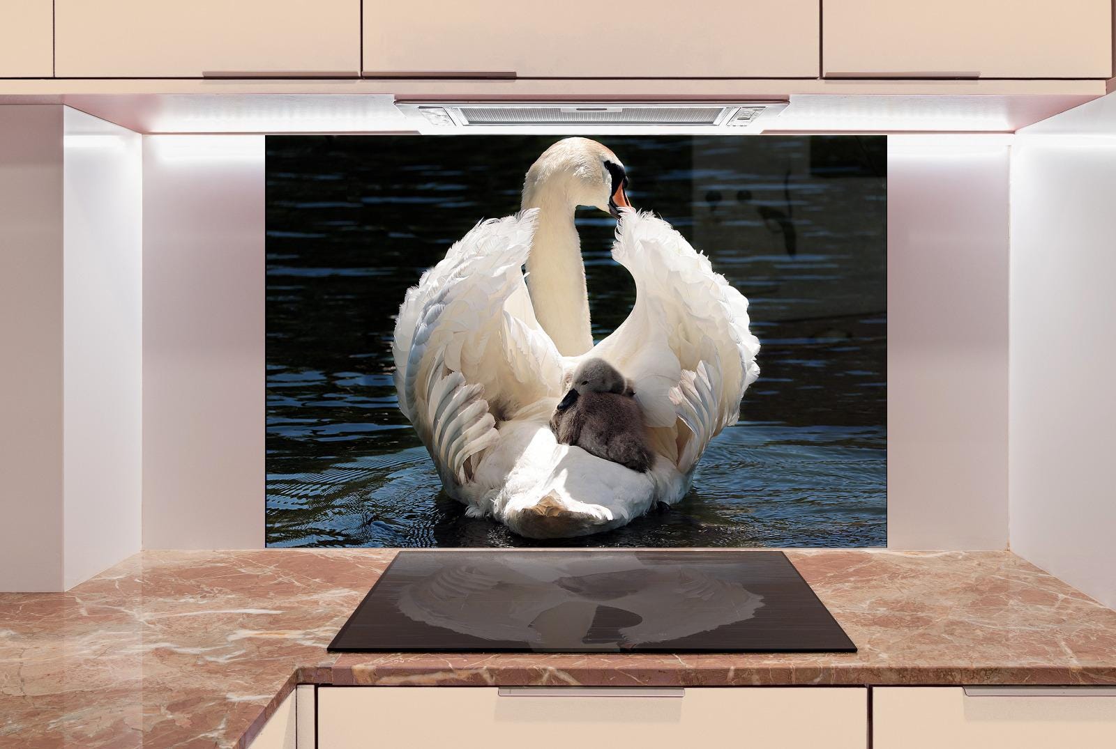 A large white swan with its wings spread out, standing on a body of water.