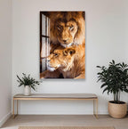 a large framed photograph of two lions, one standing and one lying down, on a wall in a room with a wooden bench and potted plants.