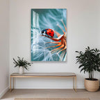 a large framed print of a ladybug perched on a dandelion, with a blurred background that emphasizes the insect. The print is hung on a white wall above a wooden bench, which is positioned in front of a potted plant.