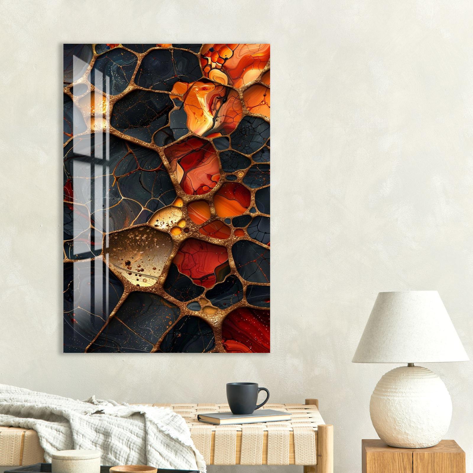 a large abstract painting with a striking color palette of red, orange, and black, hanging on a wall above a wooden table with a lamp and a coffee cup.