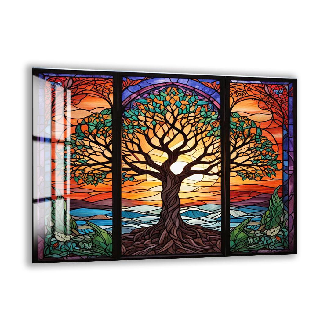 A vibrant stained glass window depicting a tree with intricate patterns and designs, set against a colorful sunset landscape.
